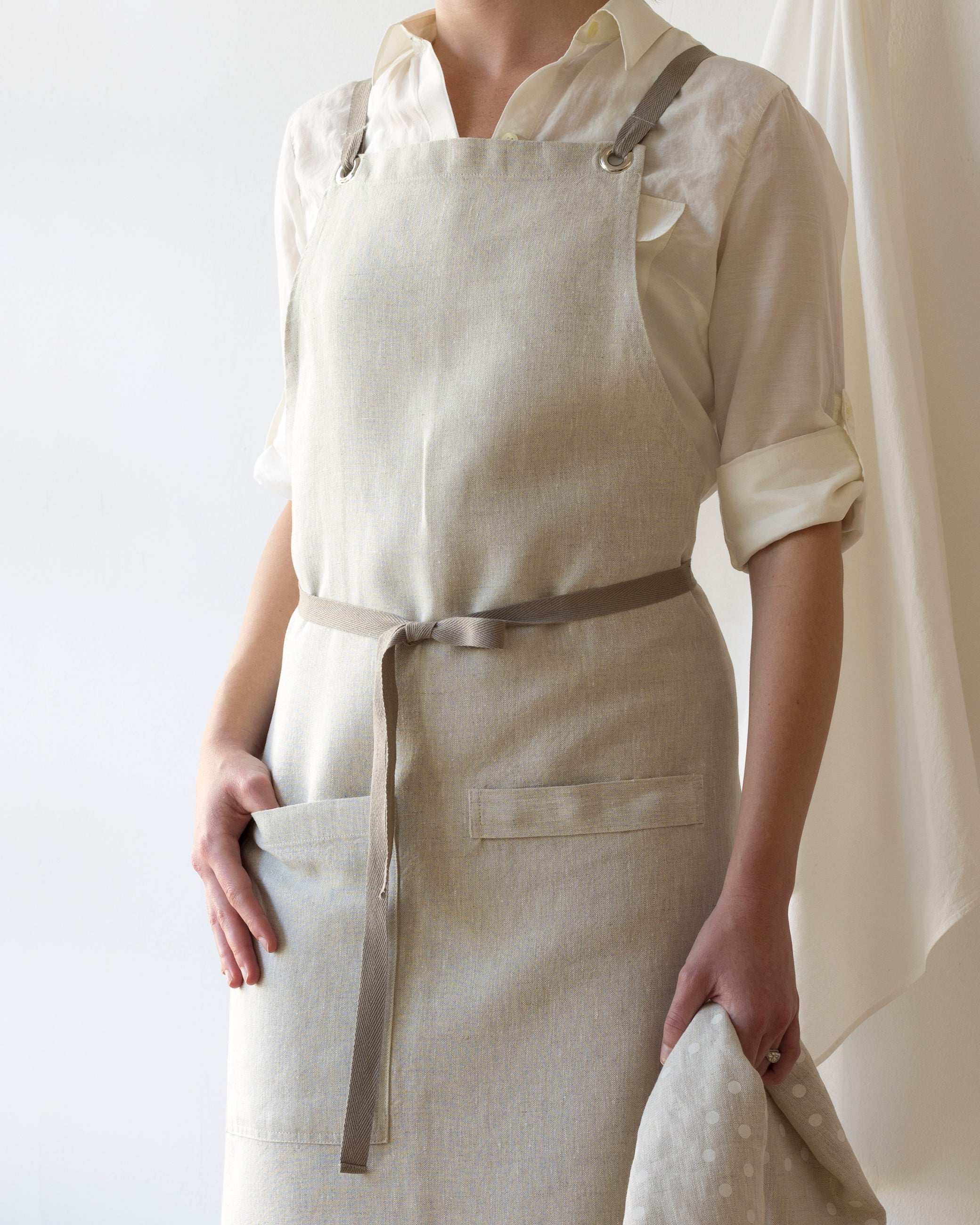 Linen cross-back apron worn front view