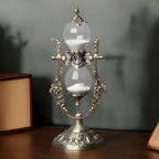 Antique gilt hourglass sand timer on a desk